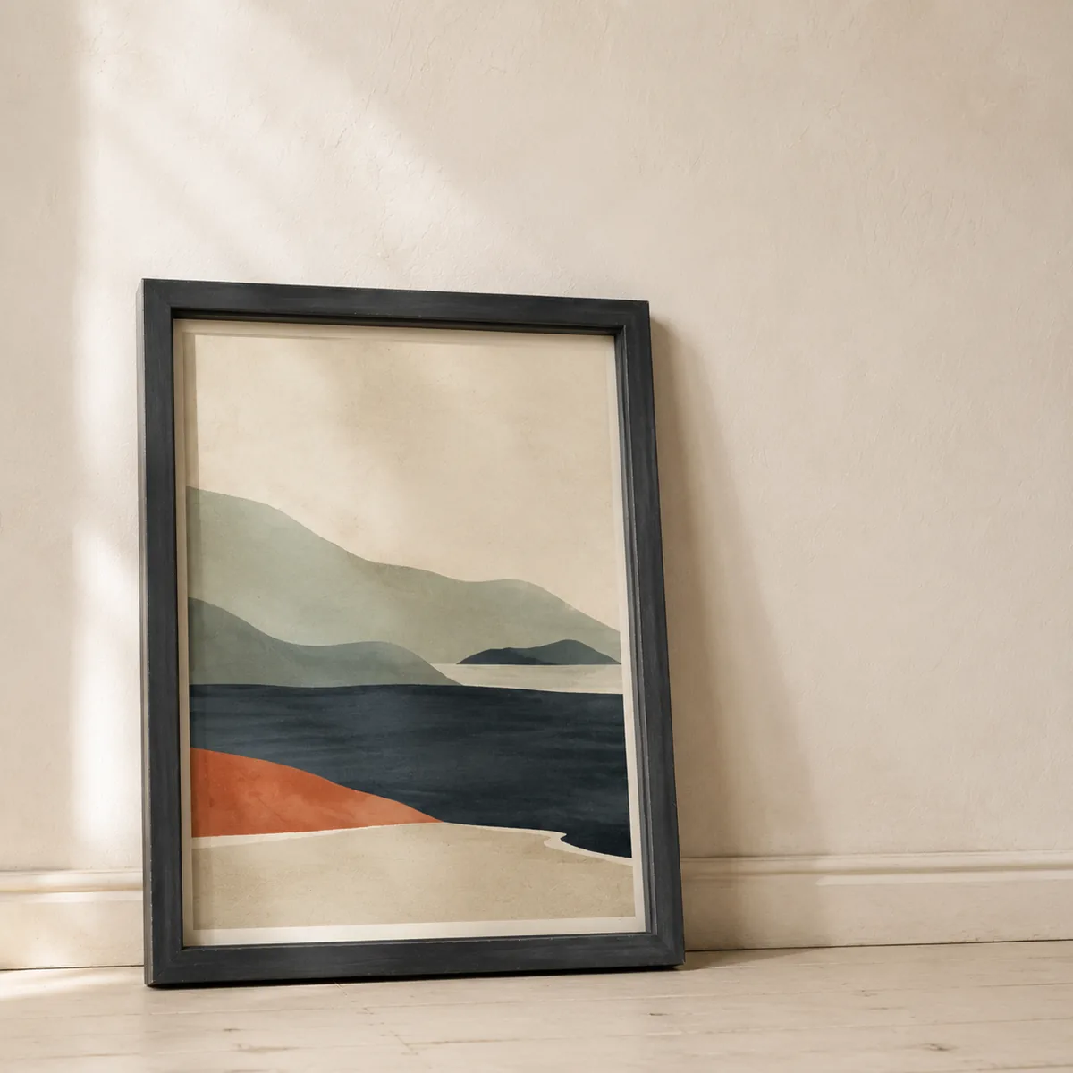 Framed abstract landscape print resting against a wall.